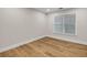 Cozy bedroom featuring hardwood floors, white trim, and a bright window at 1547 Trilogy Park, Hoschton, GA 30548