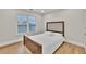 Bedroom featuring hardwood floors, neutral walls, and a bright window at 1547 Trilogy Park, Hoschton, GA 30548