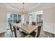 Charming dining room featuring hardwood floors, a chandelier, and a view to the entry area at 1547 Trilogy Park, Hoschton, GA 30548