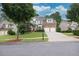 Traditional two-story home with brick and siding, manicured lawn and two-car garage at 1547 Trilogy Park, Hoschton, GA 30548