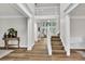 Bright foyer with hardwood floors, a grand staircase, and an open view to the living spaces at 1547 Trilogy Park, Hoschton, GA 30548