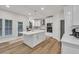 Modern white kitchen with stainless steel appliances and central island at 1547 Trilogy Park, Hoschton, GA 30548
