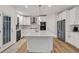 Stylish kitchen with white cabinetry, island and stainless steel appliances at 1547 Trilogy Park, Hoschton, GA 30548