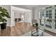 Inviting living room featuring hardwood floors, ample natural light, and access to the dining area at 1547 Trilogy Park, Hoschton, GA 30548