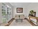 Bright living room with large windows, hardwood floors, and comfortable seating at 1547 Trilogy Park, Hoschton, GA 30548