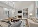 Cozy living room with a fireplace, built-in shelves, and hardwood floors at 1547 Trilogy Park, Hoschton, GA 30548