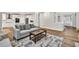 Inviting living room with a view of the kitchen, and hardwood floors at 1547 Trilogy Park, Hoschton, GA 30548