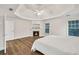 This main bedroom includes a cozy fireplace, hardwood floors, and trey ceilings at 1547 Trilogy Park, Hoschton, GA 30548