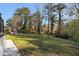 Large backyard featuring a grassy lawn bordered by mature trees and foliage at 2178 Shamrock Dr, Decatur, GA 30032
