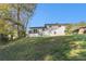 Backyard featuring lush greenery and the home's exterior with a deck and stairs at 2178 Shamrock Dr, Decatur, GA 30032
