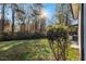 Backyard with a sunlit lawn, mature trees and access to an outdoor deck area at 2178 Shamrock Dr, Decatur, GA 30032