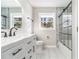 Updated bathroom featuring a marble tiled shower and a modern vanity with black accents at 2178 Shamrock Dr, Decatur, GA 30032