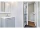 Bathroom with sleek gray vanity, modern fixtures, and a shower with elegant marble-style tiling at 2178 Shamrock Dr, Decatur, GA 30032
