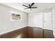 Cozy bedroom with a ceiling fan, closet, hardwood floors, and a bright window at 2178 Shamrock Dr, Decatur, GA 30032