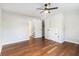 Bedroom with neutral walls, wood floors, a ceiling fan and doorways leading to other spaces at 2178 Shamrock Dr, Decatur, GA 30032