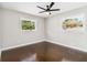 Inviting bedroom with two bright windows, a ceiling fan, hardwood floors, and neutral paint at 2178 Shamrock Dr, Decatur, GA 30032
