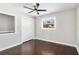 Cozy bedroom featuring neutral walls, dark wood floors, a ceiling fan, and a bright window at 2178 Shamrock Dr, Decatur, GA 30032