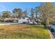 Charming white brick home with contrasting black shutters, and a beautifully maintained lawn under a clear blue sky at 2178 Shamrock Dr, Decatur, GA 30032