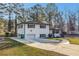 Charming white brick home featuring an attached garage and a beautifully maintained lawn and paved driveway at 2178 Shamrock Dr, Decatur, GA 30032