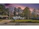 Charming home featuring a manicured lawn, and beautiful contrasting black shutters, all set under a picturesque twilight sky at 2178 Shamrock Dr, Decatur, GA 30032