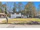 Charming home featuring a well-kept lawn, and contrasting black shutters, all set under a clear blue sky at 2178 Shamrock Dr, Decatur, GA 30032