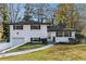 Charming white brick home featuring an attached garage and a beautifully maintained lawn at 2178 Shamrock Dr, Decatur, GA 30032