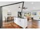 Open-concept kitchen features an island with a black countertop, stainless steel appliances, and wood floors at 2178 Shamrock Dr, Decatur, GA 30032