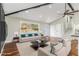 Bright living room with hardwood floors, a vaulted ceiling, a neutral sofa, and large windows at 2178 Shamrock Dr, Decatur, GA 30032