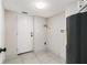 Utility room with tile floors, water heater and a white door leading to the outside at 2178 Shamrock Dr, Decatur, GA 30032