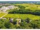 A neighborhood aerial shot displays a property nestled amidst lush greenery and nearby commercial buildings at 2573 Paul Nw Ave, Atlanta, GA 30318