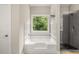 Bright bathroom featuring large soaking tub, walk in shower and window at 2573 Paul Nw Ave, Atlanta, GA 30318