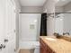 Bathroom with granite vanity, dark wood cabinets, white subway tiles and black shower curtain at 2573 Paul Nw Ave, Atlanta, GA 30318