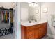 Bathroom featuring a wooden cabinet sink with large mirror and adjacent walk in closet at 2573 Paul Nw Ave, Atlanta, GA 30318