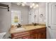 Bathroom featuring a dual vanity with dark cabinets, granite counters and decorative mirrors at 2573 Paul Nw Ave, Atlanta, GA 30318