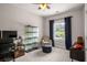 Cozy bedroom with ceiling fan, display case, and comfortable upholstered chair at 2573 Paul Nw Ave, Atlanta, GA 30318