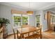 Bright dining room featuring hardwood floors, modern lighting and large windows overlooking a porch with a wooded view at 2573 Paul Nw Ave, Atlanta, GA 30318
