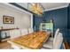 Elegant dining area with a wooden table, stylish chandelier, and sophisticated blue walls at 2573 Paul Nw Ave, Atlanta, GA 30318
