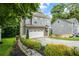 Stylish home boasts a two-car garage, complemented by lush landscaping and gray siding at 2573 Paul Nw Ave, Atlanta, GA 30318