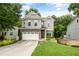Charming home featuring gray siding, stone accents, and a two-car garage at 2573 Paul Nw Ave, Atlanta, GA 30318