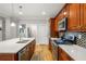 Kitchen with stainless steel appliances, wooden cabinets, quartz countertops and an island with a sink at 2573 Paul Nw Ave, Atlanta, GA 30318
