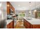 Spacious kitchen with stainless steel appliances, quartz countertops and a dining area overlooking a wooded view at 2573 Paul Nw Ave, Atlanta, GA 30318