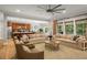 Open-concept living room flows into the kitchen, featuring a ceiling fan and hardwood floors at 2573 Paul Nw Ave, Atlanta, GA 30318
