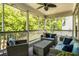 Relaxing screened porch with comfortable seating and ceiling fan overlooking wooded area at 2573 Paul Nw Ave, Atlanta, GA 30318