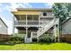 A two-story home shows a large, elevated, screened porch overlooking the well maintained lawn at 2573 Paul Nw Ave, Atlanta, GA 30318