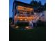 Rear view of a house featuring a screened in porch decorated with outdoor lights at dusk at 2573 Paul Nw Ave, Atlanta, GA 30318
