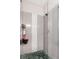 Modern walk-in shower with neutral colored tile, decorative strip and black hardware at 2573 Paul Nw Ave, Atlanta, GA 30318