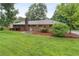 Large backyard features lush green grass and trees at 2644 Hickory Valley Dr, Snellville, GA 30078