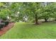 Lush backyard features mature trees and landscaping at 2644 Hickory Valley Dr, Snellville, GA 30078
