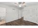 Bright bedroom features a ceiling fan, hardwood floors, and a large closet for storage at 2644 Hickory Valley Dr, Snellville, GA 30078