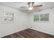 Bedroom features hardwood floors, two windows, and blank walls ready for personalization at 2644 Hickory Valley Dr, Snellville, GA 30078